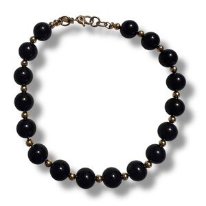 Vintage Monet signed black bead and gold tone spacers bracelet. 8”